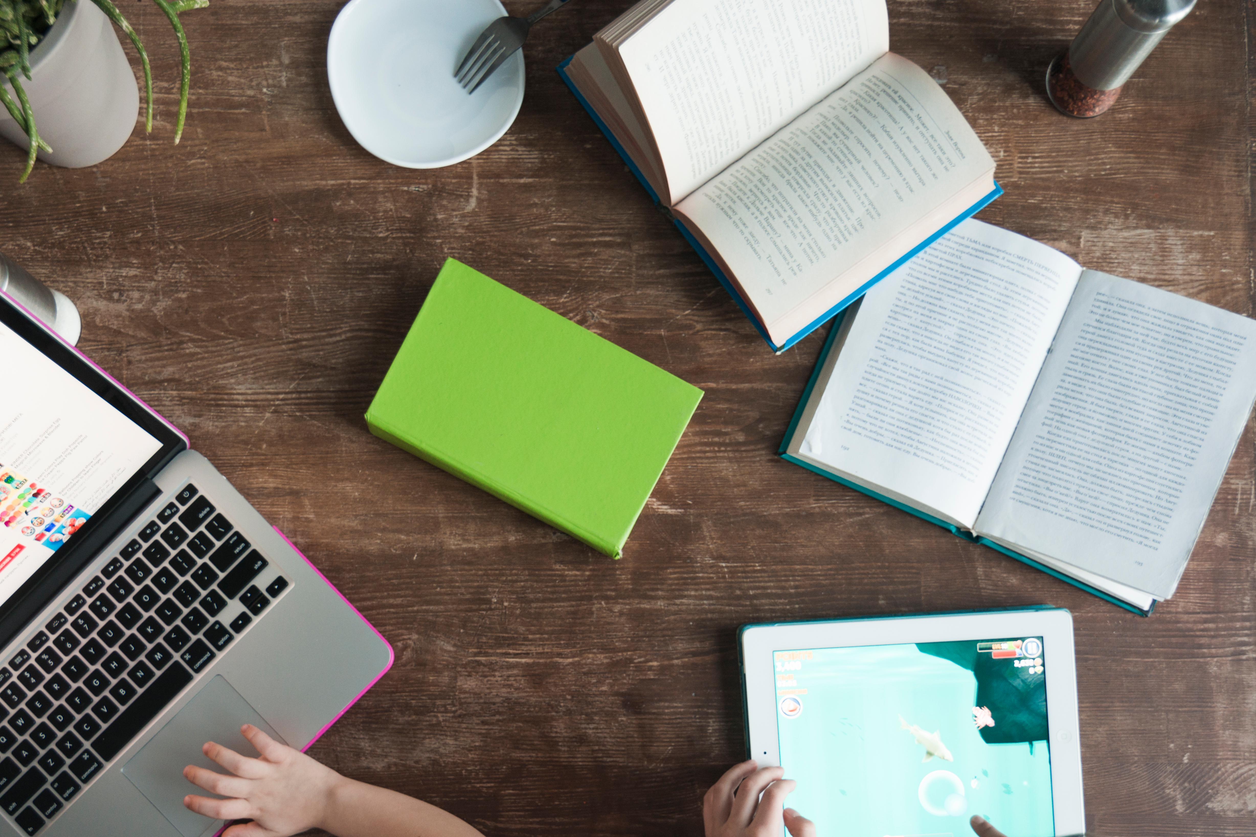 two kids learning with laptop, tablet and books